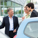 couple checking out a car